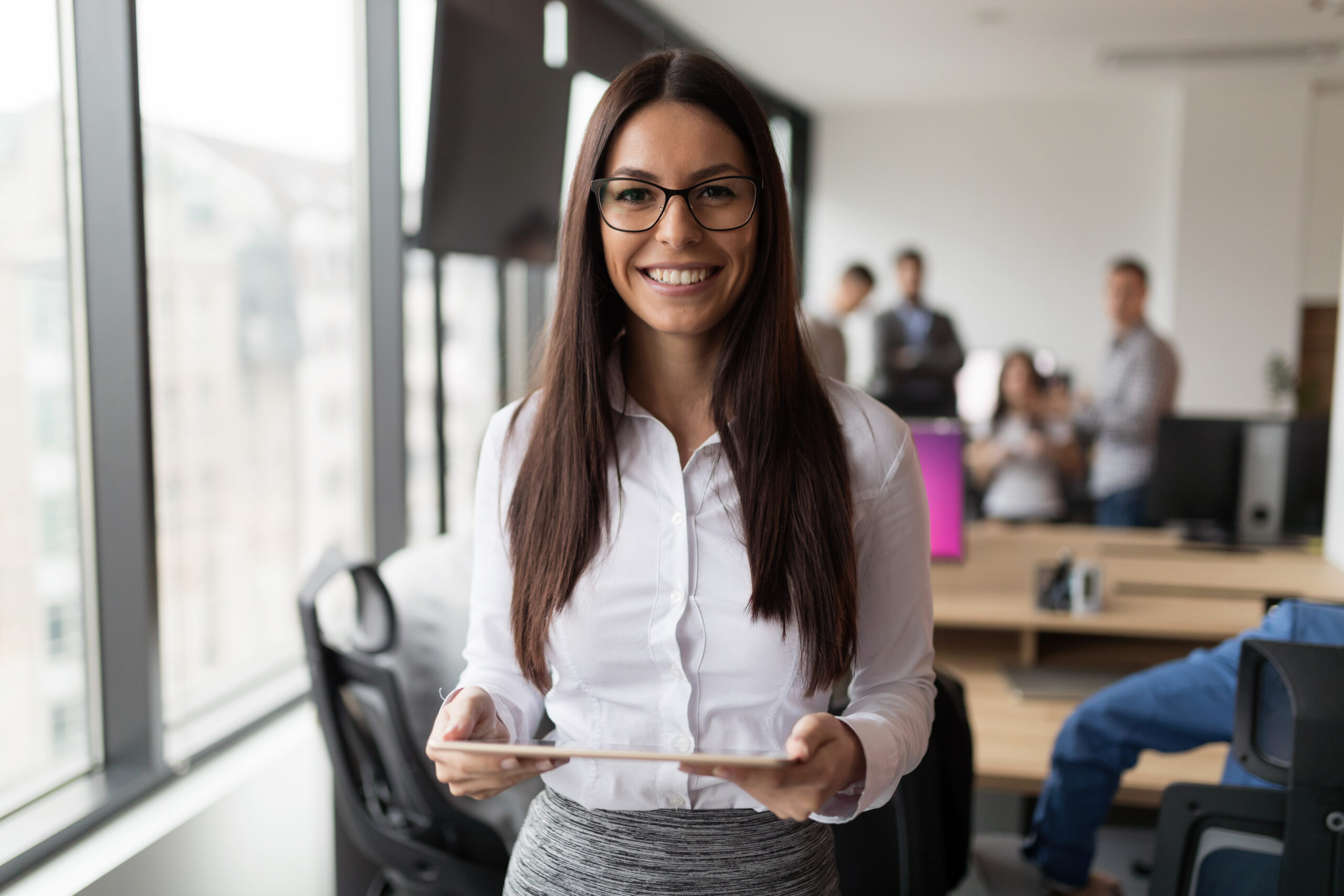 Portrait of successful businesswoman holding digital tablet